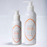 Two-bottles-of-Natural-Harmony-Body-and-Joint-Rub-on-a-light-gray-background